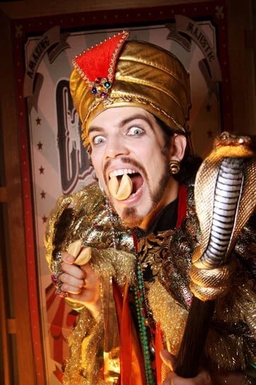 The comic fortune teller in a gold turban pulling a face