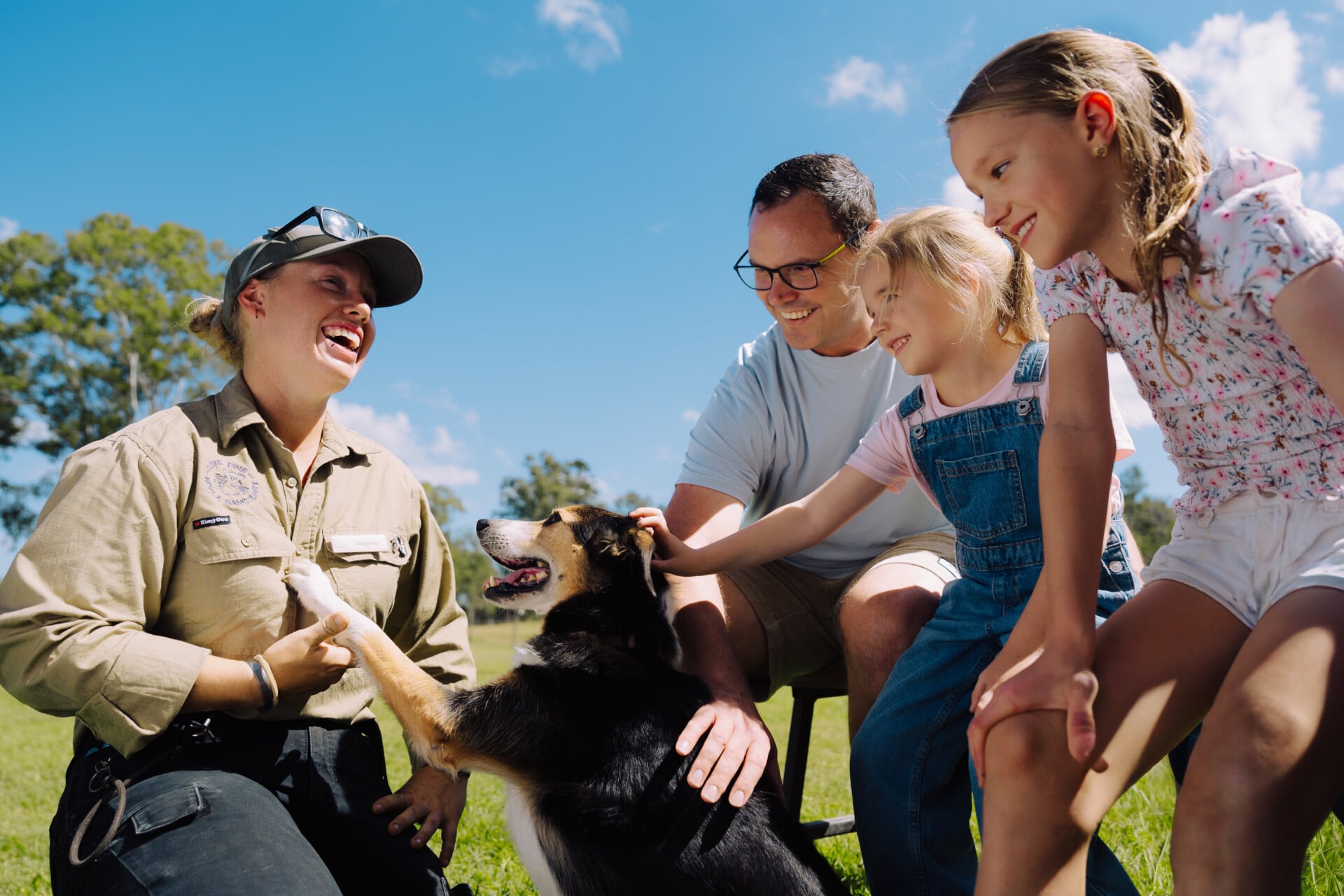 Family meeting a sheepdog during the Sheepdog Encounter at Lone Pine Koala Sanctuary